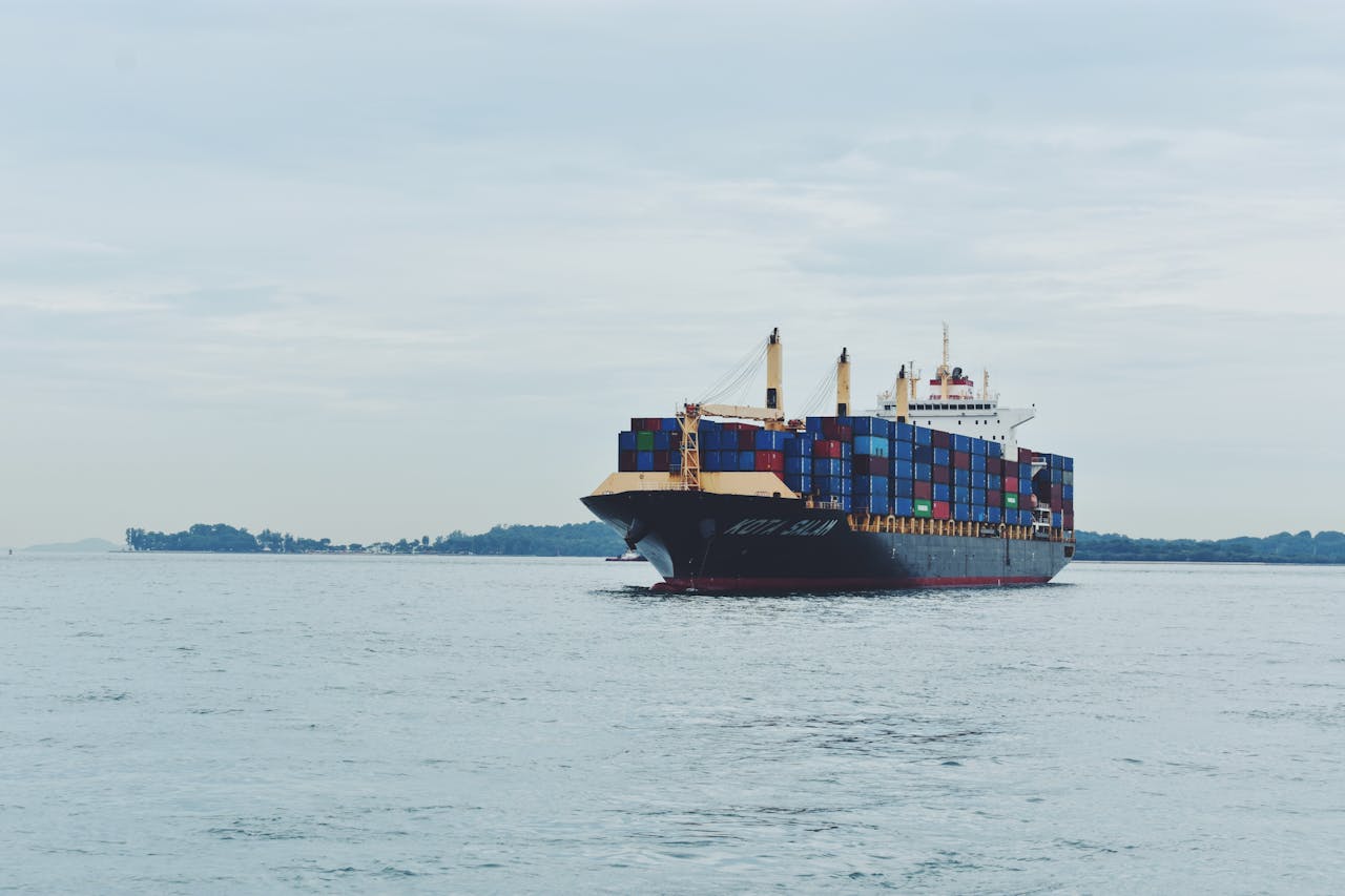 Crafting Captivating Headlines: Your awesome post title goes here Large cargo ship transporting containers across a calm sea, symbolizing global logistics.