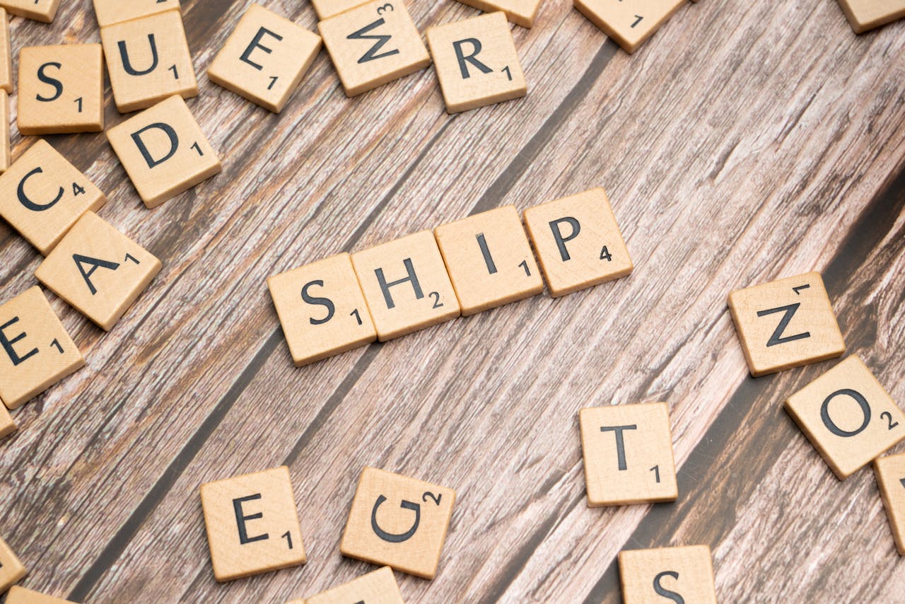 The Art of Drawing Readers In: Your attractive post title goes here Wooden Scrabble tiles forming the word ship on a rustic wooden surface.